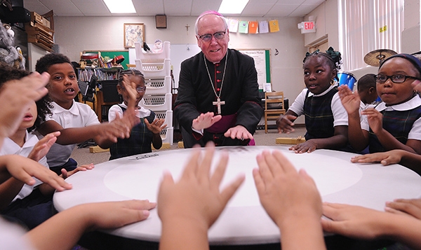 Bishop Richard Malone joins the drum circle in music class on the first day of school with St. Joseph University School students on Main Street, Buffalo. (Dan Cappellazzo/Staff Photographer)